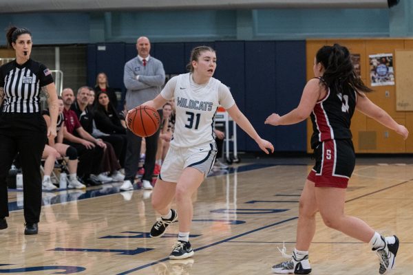 Gabi Moultrie crosses over #11 from Tualatin. Wilsonville would go on to win this game 39-38. Photo provided by Greg Artman.