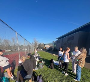 The Wilsonville Girls Tennis gather outside the courts, patiently waiting to play. Later, both teams went their line-ups and started the matches. 