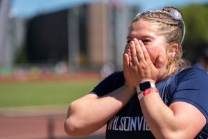 Avery Devincenzi in awe after learning that she has broken the shot put record at Wilsonville High School. Devincenzi looks to continue to break her records and place well in the district and state meet. Photo provided by Michael Williams.