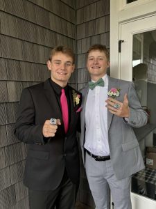 Seniors Luke Larson and Mason Seal show off their championship rings before prom. The ring was sized seven, which is the biggest possible size for  championship rings. Photo provided by Mason Seal.