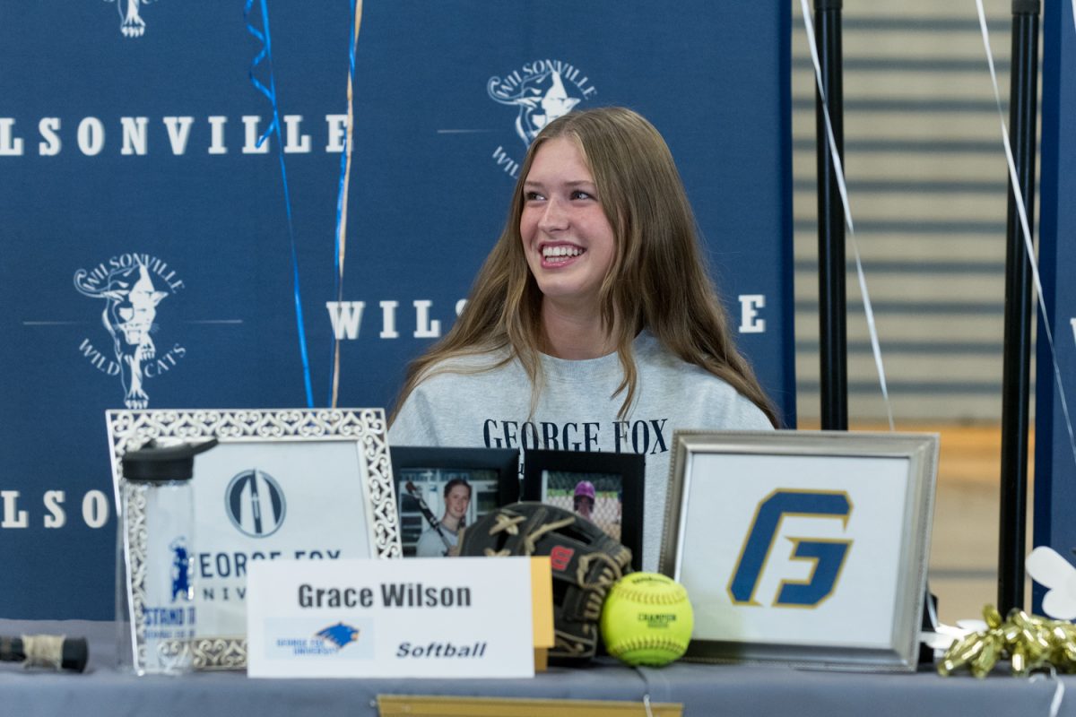 Grace+Wilson+during+her+signing+day+where+she+signed+her+Letter+of+Intent+to+play+softball+for+George+Fox+University.+Wilson+signed+alongside+her+friends+and+classmates.+Photo+provided+by+Greg+Artman.
