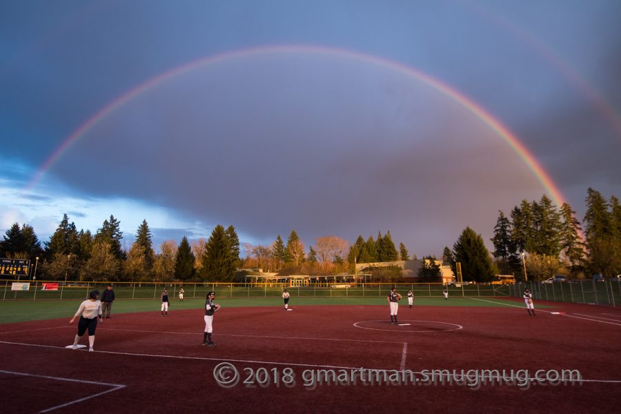 Girls softball plays under lucky rainbow. But the rainbow wasn't enough to capture the win.  