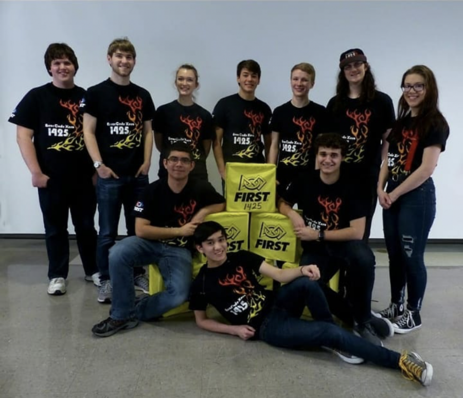 The robotics team poses for a photo at .a meeting. The team is getting ready for their competition season.