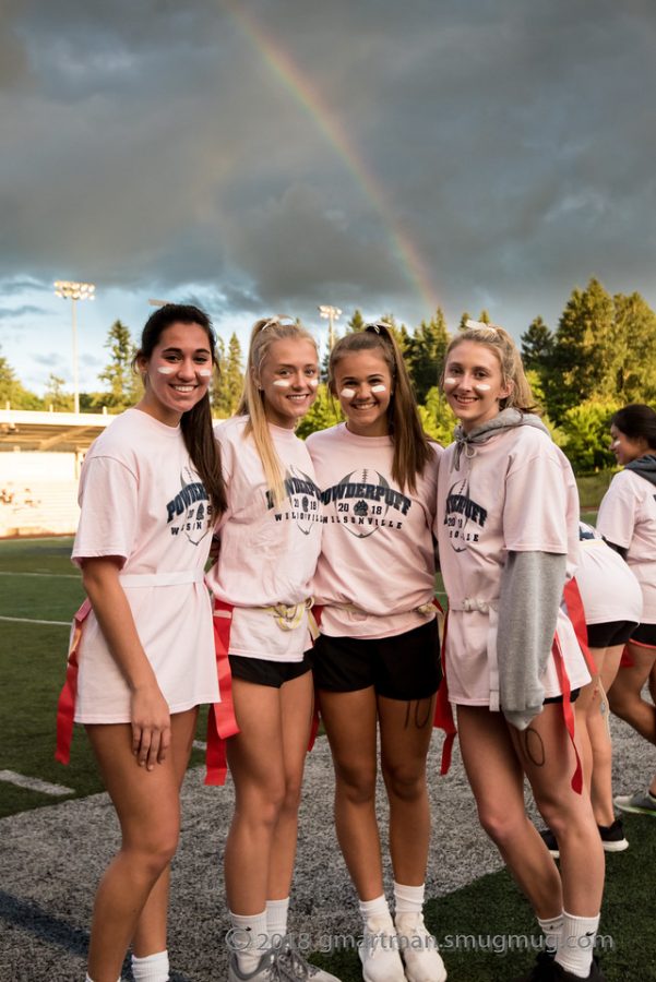 Sydney Carskadon, Lainnee Robinson, Julia Huchler, and Hannah Scott stand under a rainbow after winning the championship game. 