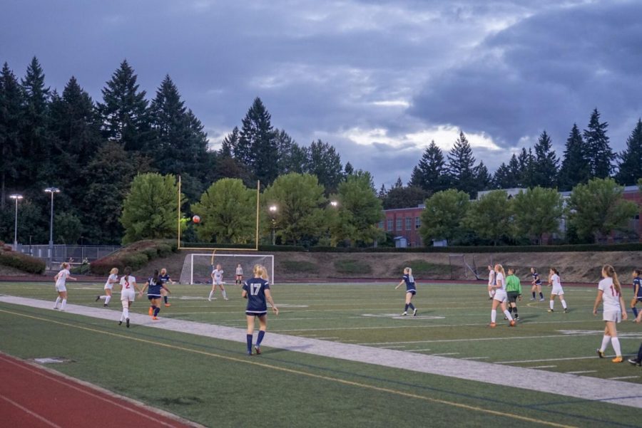 Girl's varsity soccer game at Randall Stadium during the preseason. Wildcats and Cardinals prepare themselves to contest the ball as it is seen coming down to earth.