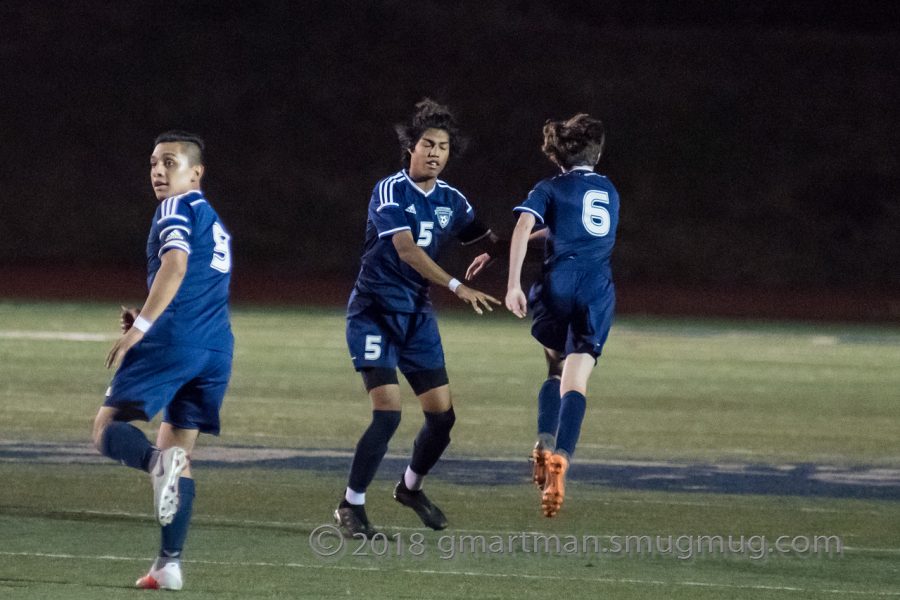 #6 Matthew Little runs past Angel Ulloa on his way back to defense