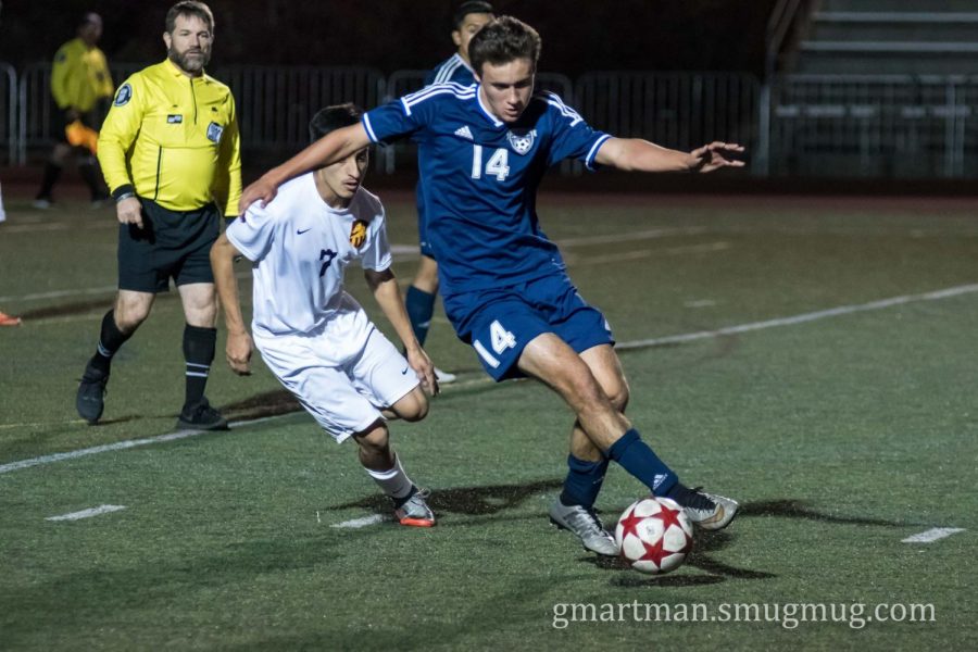 Sam Blohn attacks the ball as the Cats take on the Mustangs.  Blohn scored one of Wilsonville's two goals, but the rally was unsuccessful