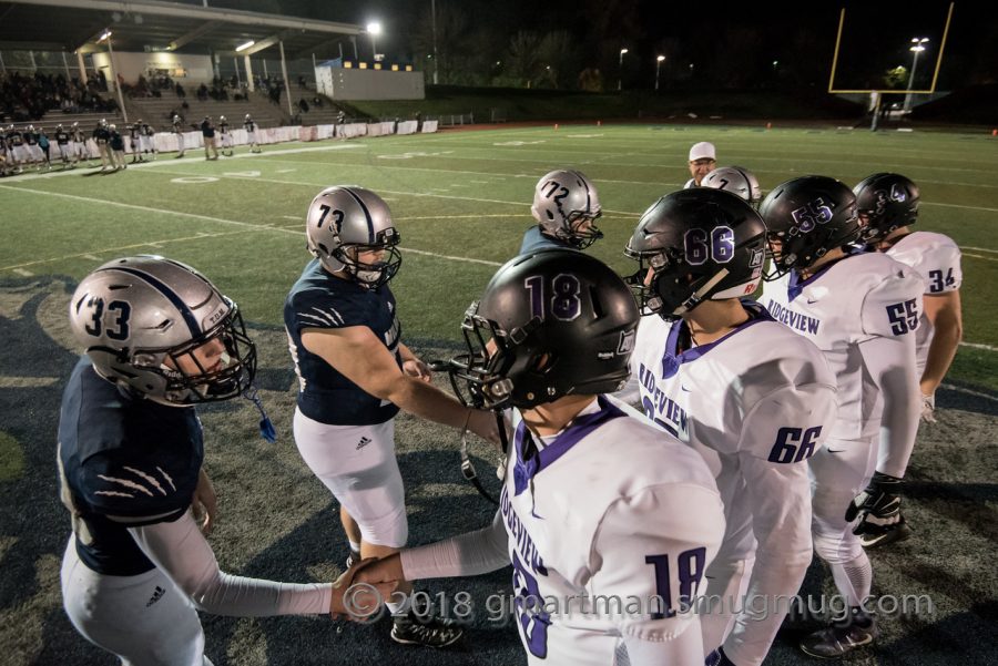 Wilsonville team captains shake hands with Ridgeview players before kickoff. 