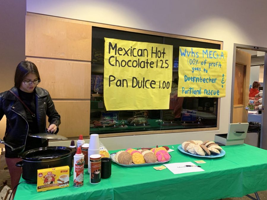 MEChA students at Holiday Bazaar selling hot chocolate and conchas. Proceeds will go to Doernbecher and Portland Rescue.