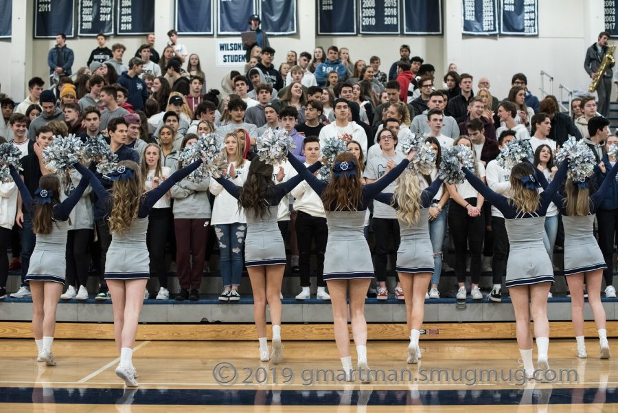 The cheer team roots on the Wildcats. Wilsonville captured the win on senior night. 