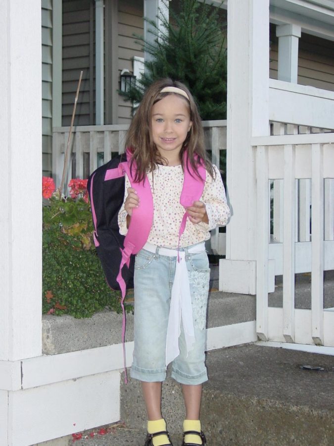 Senior Aly Johnston smiles on her doorstep before her first day of kindergarten. Photo credit Aly Johnston.