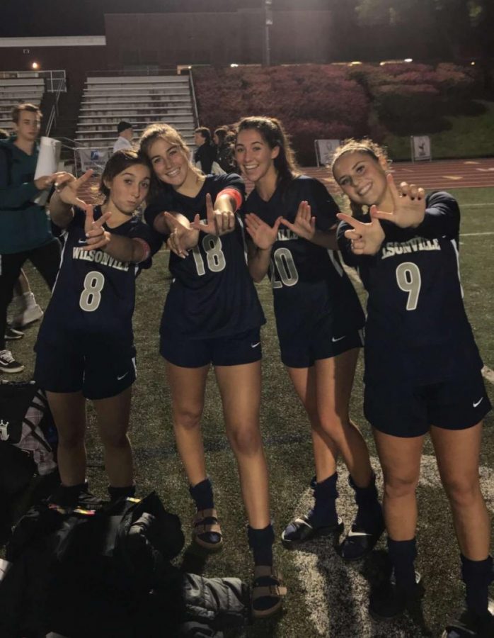 Seniors Haley Stahl, Kylie Aube, Sydney Carskadon, and Courtney Ellis celebrating tonight's big victory over Canby.