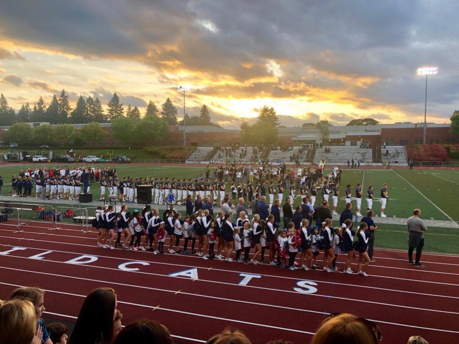 The choir sings the National Anthem at hoco.