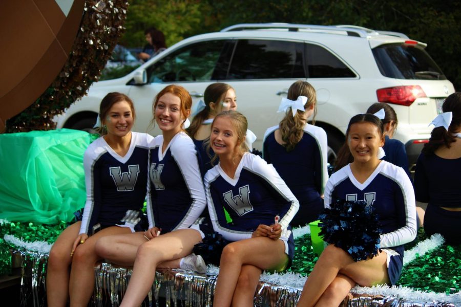 Cheerleader Grace Wilhelm poses with teammates Halle Schieres, Emma Dougherty and Jenna Garlitz. The team handed out candy to the kids watching the parade.