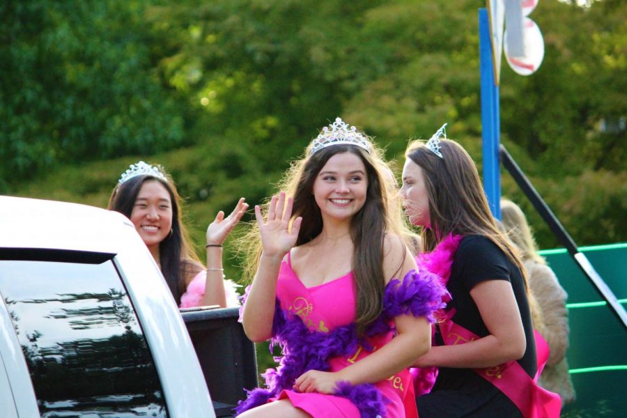 Jackie Foltz waves at people watching the parade. The seniors float was Vegas and some of them were dressed as bridesmaids. 