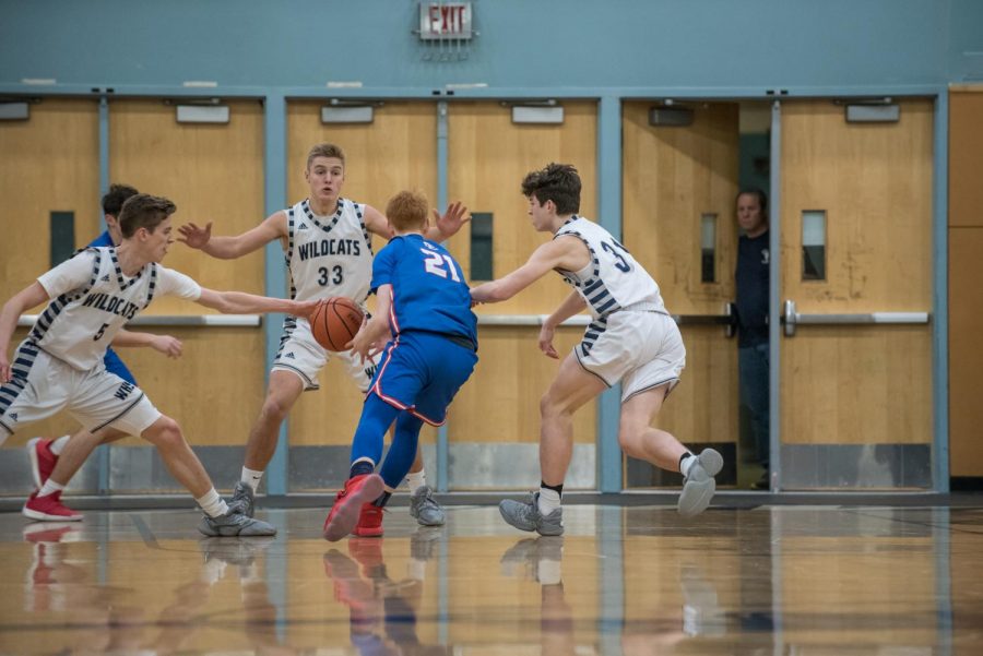 Riley Scanlan(#5), Kellen Hartford(#31), and Chase Hix(#33) play defense against La Salle.