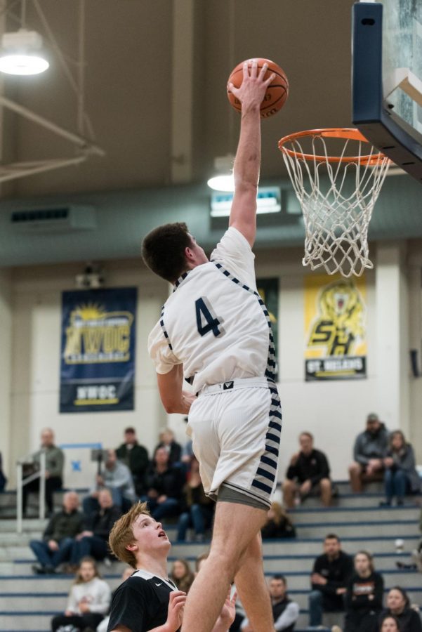 Senior Dakota Reber going up for a dunk, during the second half on this past Friday's game.