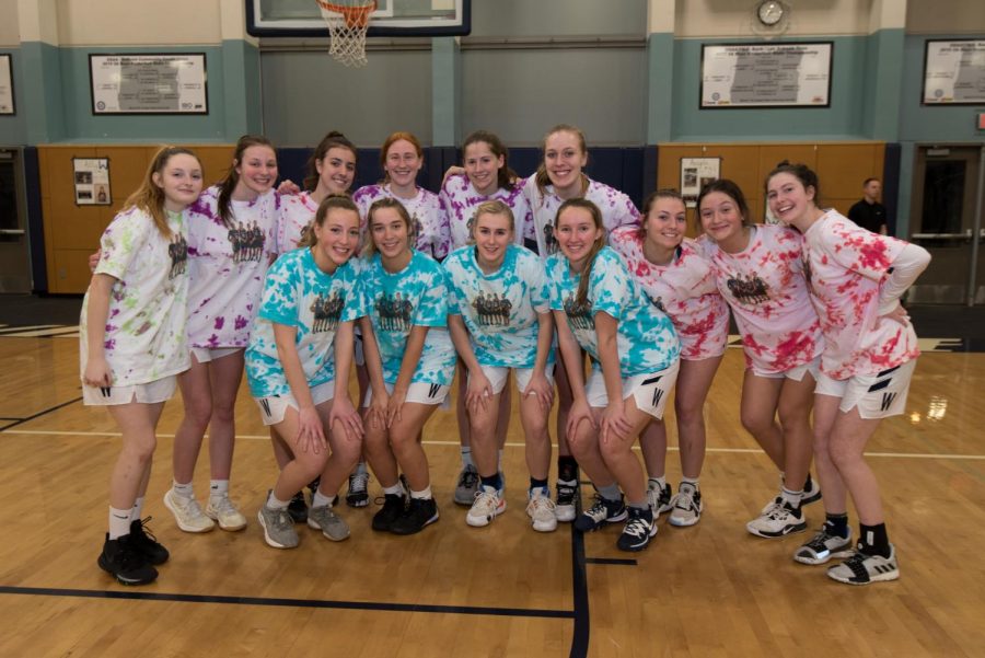 The Wildcat seniors pose with their team prior to Tuesday night's game. The underclassmen made special shooting shirts for senior night.