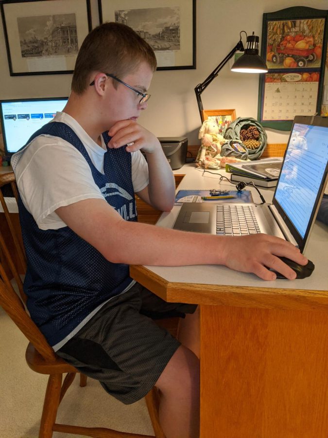 Michael Hassler concentrates on an online assignment.  Distance learning presents challenges for students and teachers.