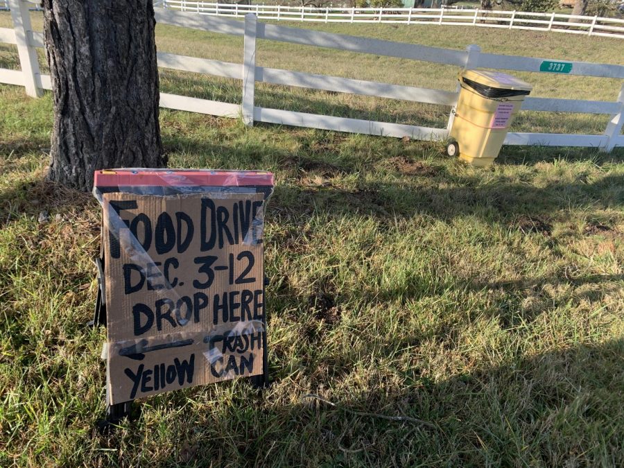 Food Drive sign next to food drive bin. Food drive sign found on SW Homesteader Rd. 