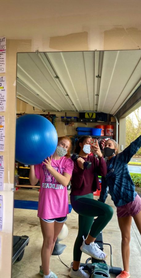 Seniors Madison Koellermeier, Sydney Burns, and Lily Wright doing an at home workout.