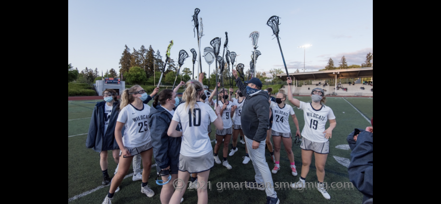 Girls Lacrosse team in the post-win huddle. Photo belongs to Greg Artmen