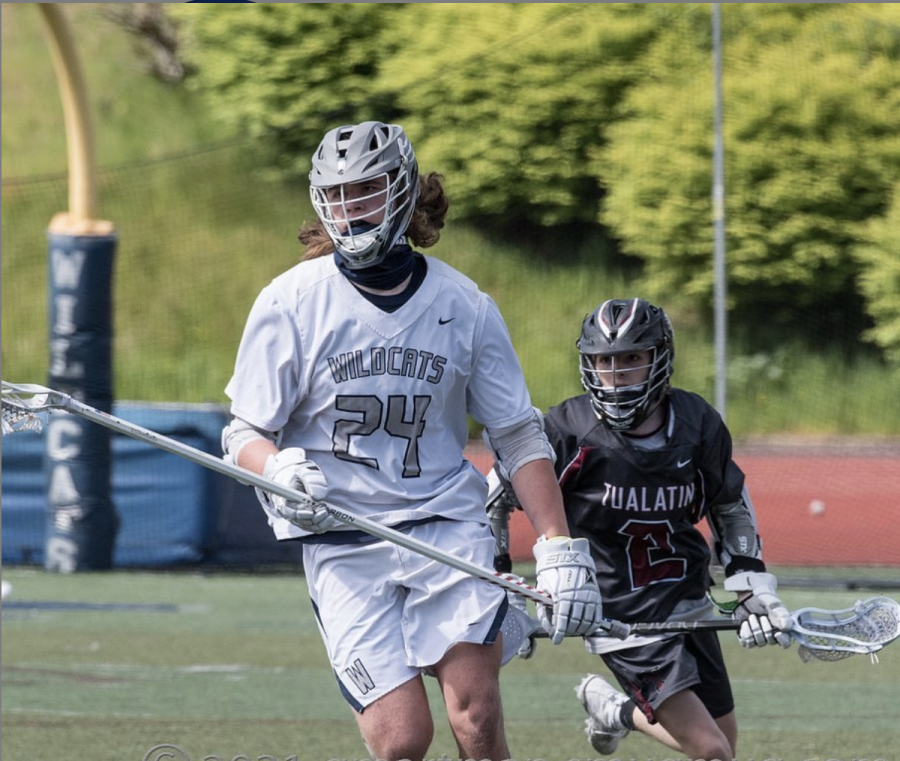 Wyatt Bedell playing lacrosse against tualatin. 