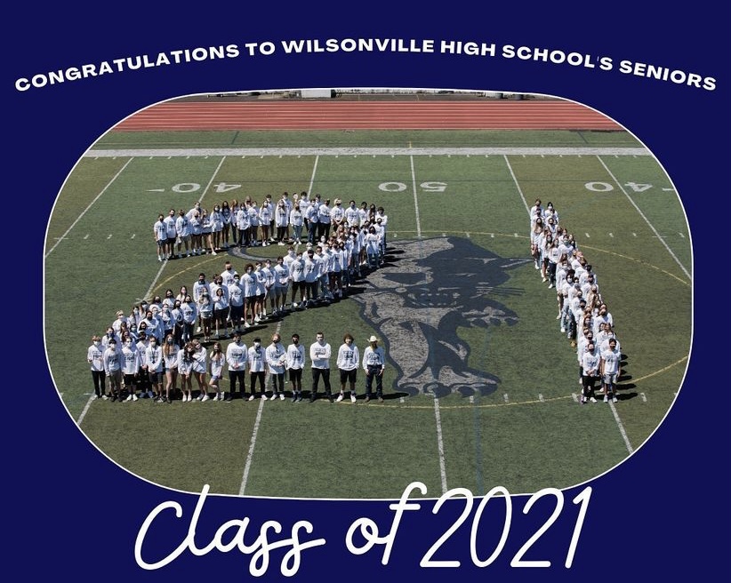 Class of 2021 stand on the main field at Randal Stadium, creating a 21. Photo belongs to WBN