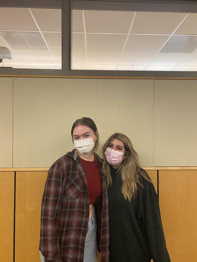 Juniors Elle Bidwell and Katy Bennet pose in front of one of their classrooms.