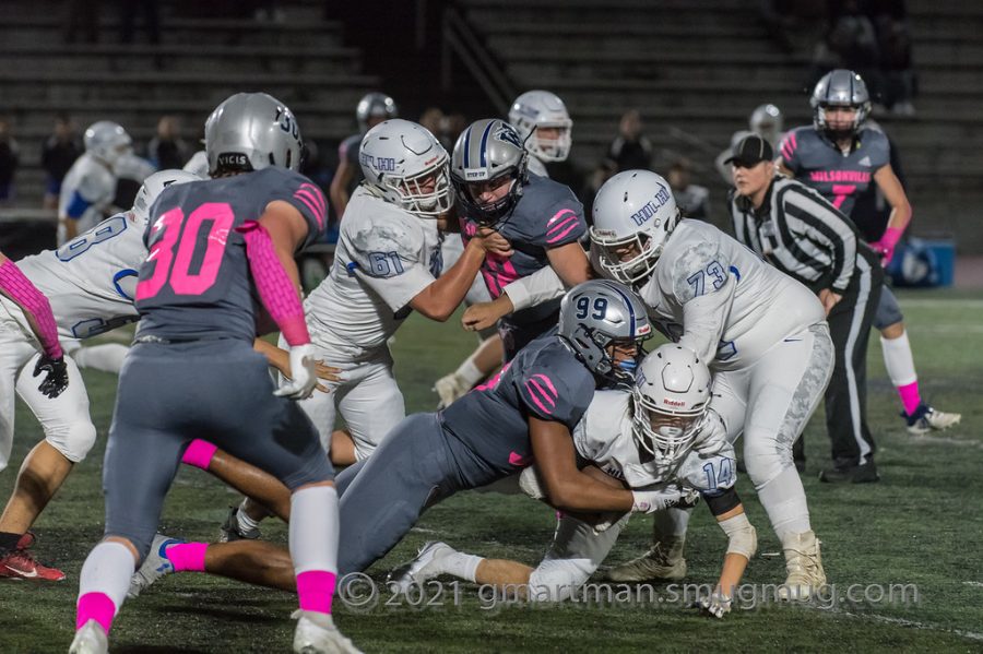 Tristan Davis finishes a tackle in a dominant Wilsonville victory.