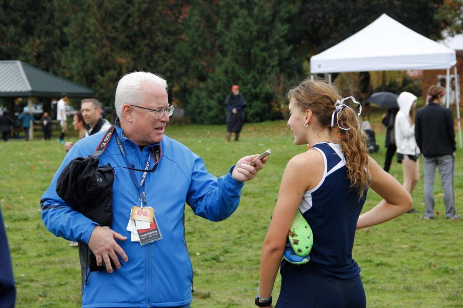 Gabby Prusse doing a post race interview after finishing as Wilsonville's lead in the district meet. 