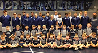 The Varsity Wrestling team from last season. Posing with the future of Wilsonville Wrestling.