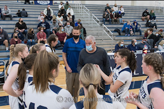 Girls Basketball huddling during timeout. They went on to win 49-37.