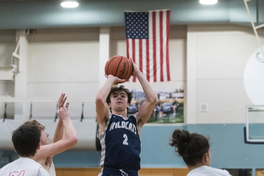 Senior Enzo Chimienti shoots a jump shot against North Eugene in the Cats' opening tournament. Chimienti is a starting guard for the Cats and is a consistent scorer for their offense. 