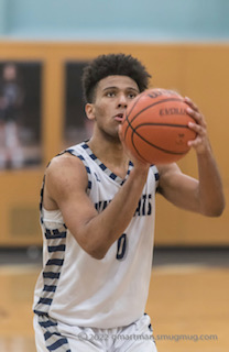 Junior Tristan Davis putting up a free throw. The Cats went on to win 63-55.