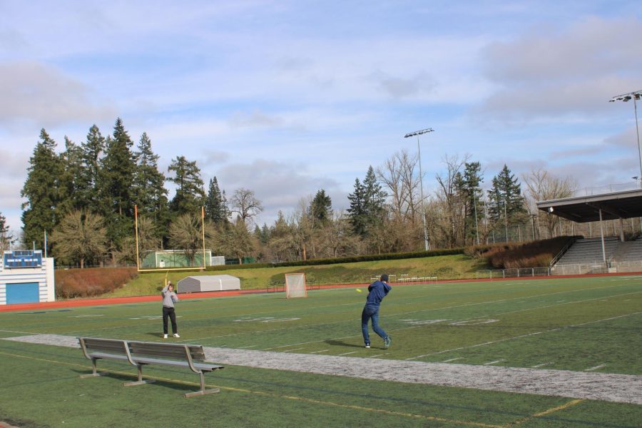 The tenth of a second before Anthony Saccente sends the ball to the moon from a dime setup by Cole Miller. The warm weather has encouraged students to spend more time outside lately.