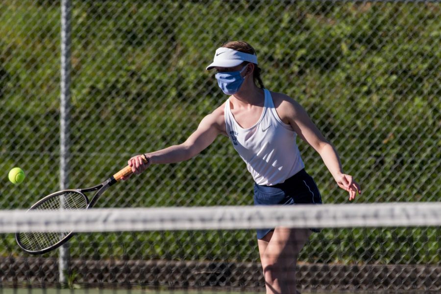 Current senior Rachel Westing hits a forehand in a home match against Hillsboro. The Cats' last season was a success, and they hope to carry this into this year's season.