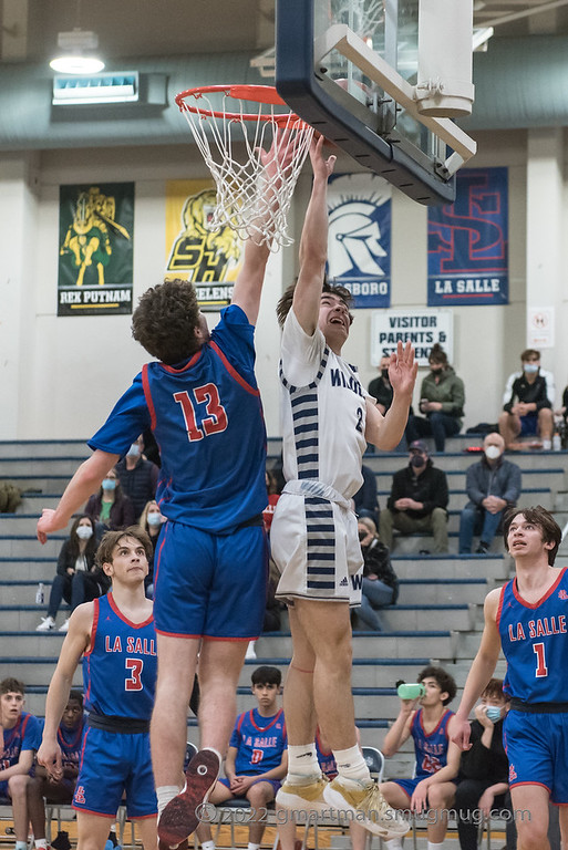 Enzo Chemienti finishes a tough shot at the rim As Finbar o'Brien tries to block his shot.