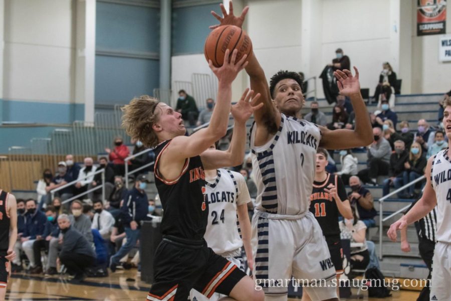 Tristan Davis ferociously blocks Chris Stoddard in a 42-32 Wilsonville win.