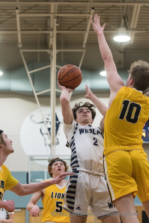 Enzo Chemienti rises up attempting a very contested floater in a 54-16 victory over St. Helens.