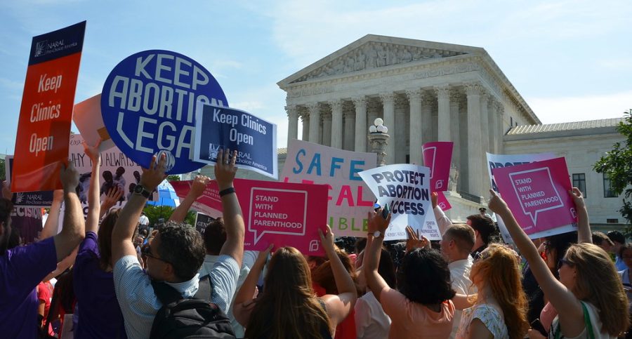 People protest on the steps of the Supreme Court. Despite the decision not yet being final, people have swarmed to the court to oppose the opinion. 