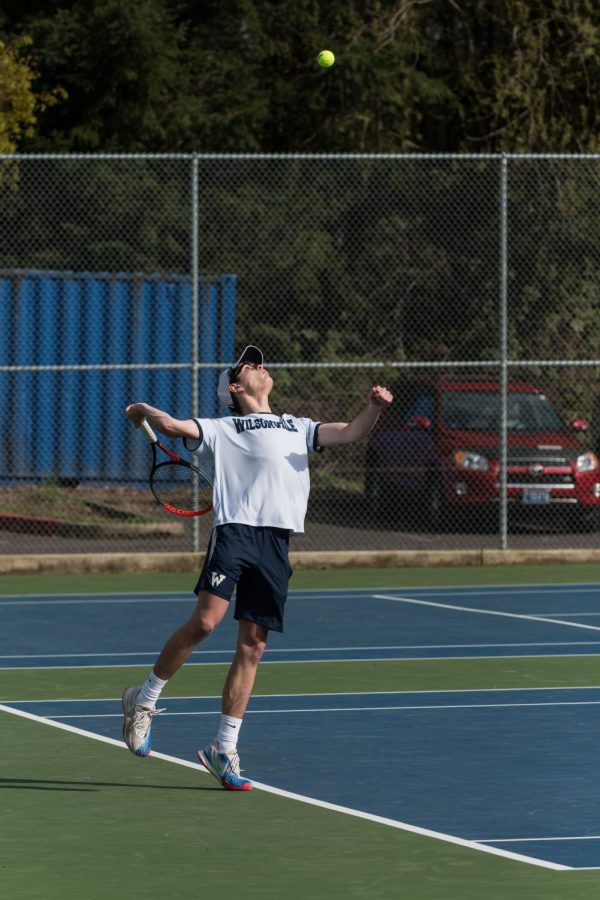 Ben Pinoli serves the ball.