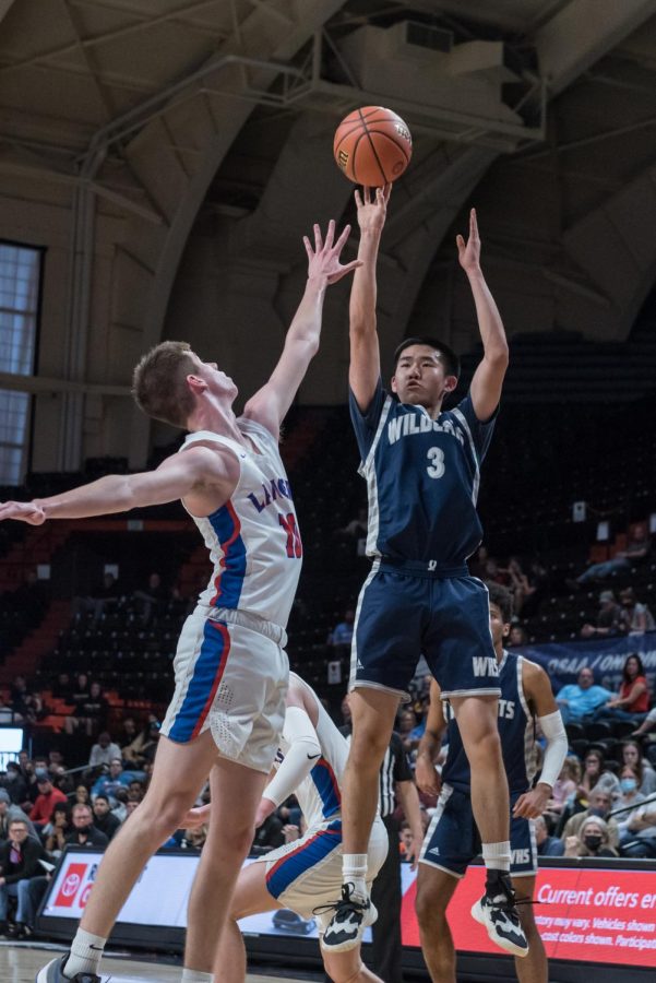 Junior Maxim Wu goes up for a shot in the state semifinals against Churchill. The Cats won this game, which carried them through to the championship where they took the state title.