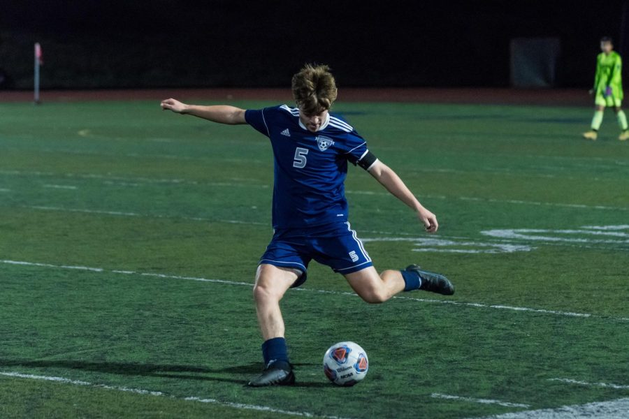 Senior Cameron Little kicks the ball up the field. The boys defeated Hillsboro 5-0. 