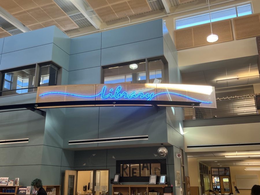 The neon blue sign "Library" vibrantly marks our school's library.