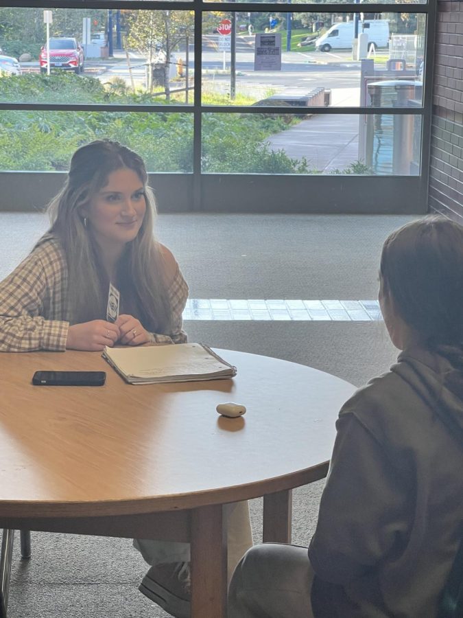 Emily Barry (senior) smiling while enjoying a nice conversation with her fellow classmate. 