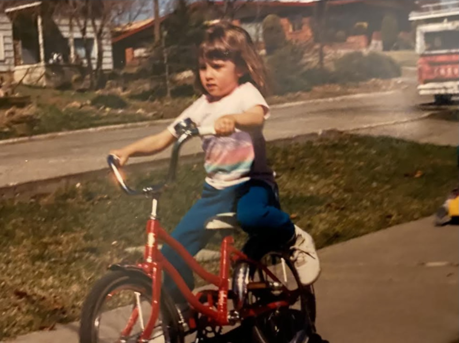 Mrs. Schaaf learning to ride a bike for the first time-- accomplishing her first big triumph.