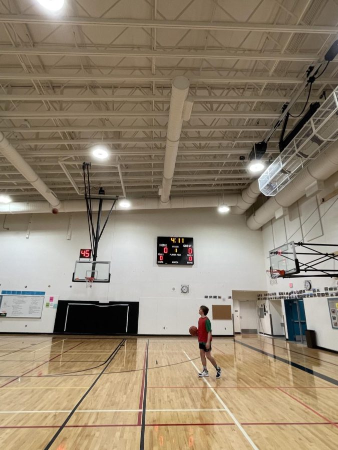 Junior Grayson Atwood stares in awe at the amazingly high arc of Luke Larsons three-pointer from the left wing. You can tell the shot has a lot of spin in it just by looking at the ball at the top left, it’s also several meters above the rim. 