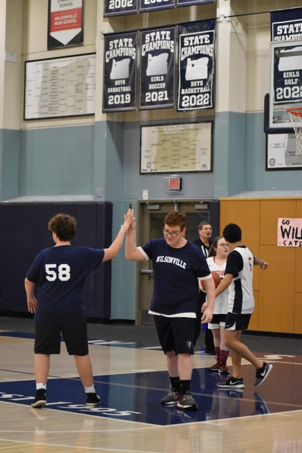 Cole McCanaughy and Bryce Bartham high-five after Bryce makes an excellent shot. He was one of the leading scorers in this game. 