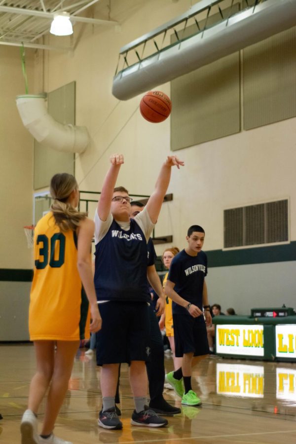 Bryce Barham going up for a shot on senior night. This helped Wilsonville beat the competition .